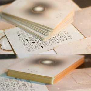 Stack of cards with text and decorative elements on a surface of cards laid out