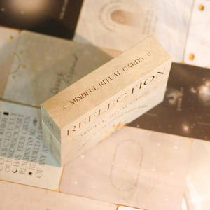 Box of 'Mindful Ritual Cards' on a surface covered with cards laid out