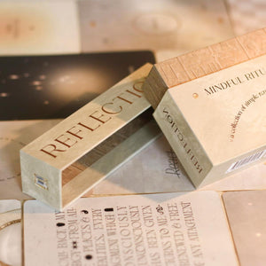 card deck box opened labeled 'Reflection' and 'Meditation' on a surface of cards laid out
