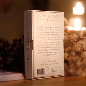 Cardboard box with text 'Messages of Grace' on a wooden surface with blurred background