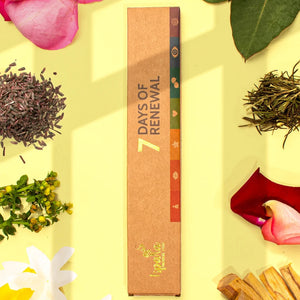 Box labeled '7 Days of Renewal' surrounded by tea leaves, flowers, and wooden sticks on a yellow background