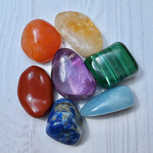 Collection of colorful crystals on a light wooden surface