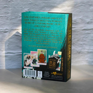 The back and spine of “Ask the Canine Sages” oracle deck box, featuring a teal and black design with gold text and illustrations of dog-themed cards.