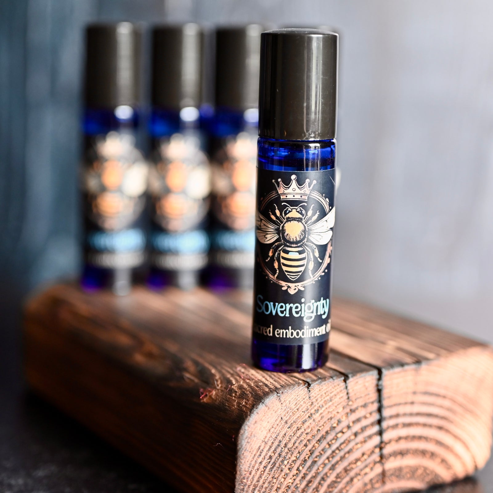 close up picture of roll on with back label with yellow bee on roll on bottle with crystals around