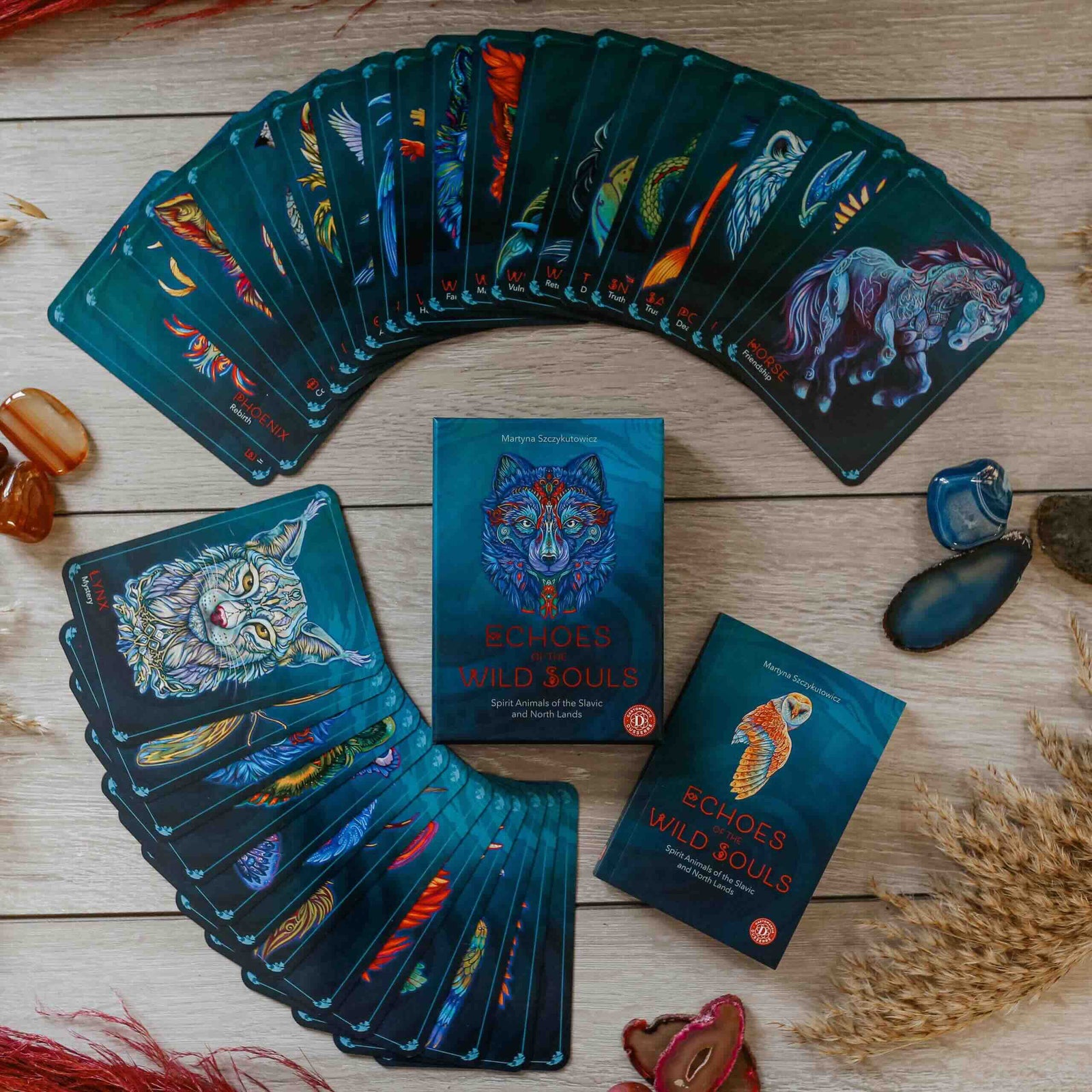 An oracle deck box titled "Echoes of the Wild Souls" by Martyna Szczykutowicz, featuring a stylized colorful wolf head on a dark teal background.
