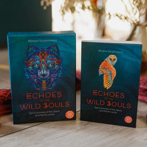 Teal oracle box with wolf head and guidebook with owl titled "Echoes of the Wild Souls" by Martyna Szczykutowicz on a wooden surface. 