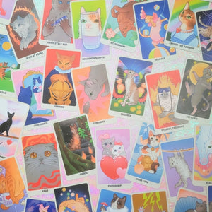 Collection of colorful oracle cards with cat illustrations on a white background