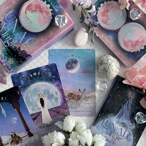 Lunar Magic Oracle cards with flowers and crystals on a textured surface