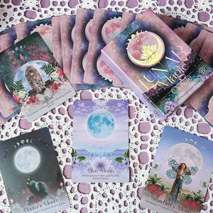 Collection of oracle cards with moon phases and nature-themed designs on a textured surface.