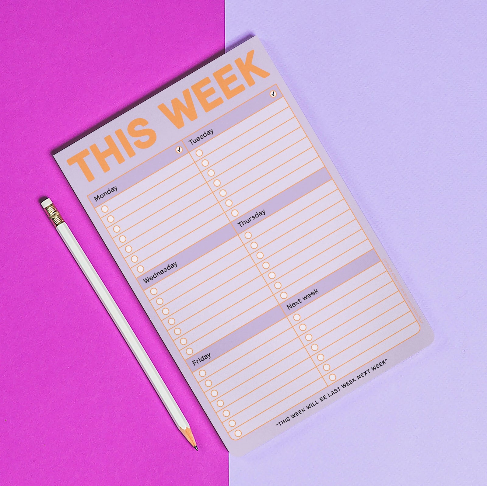 Weekly planner pad with a pencil on a pink and purple gradient background