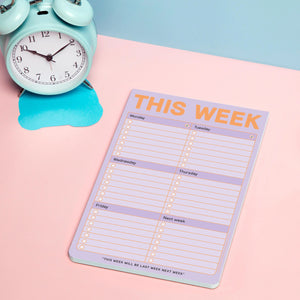 Weekly planner sheet with 'This Week' heading next to a turquoise alarm clock on a pink and blue background