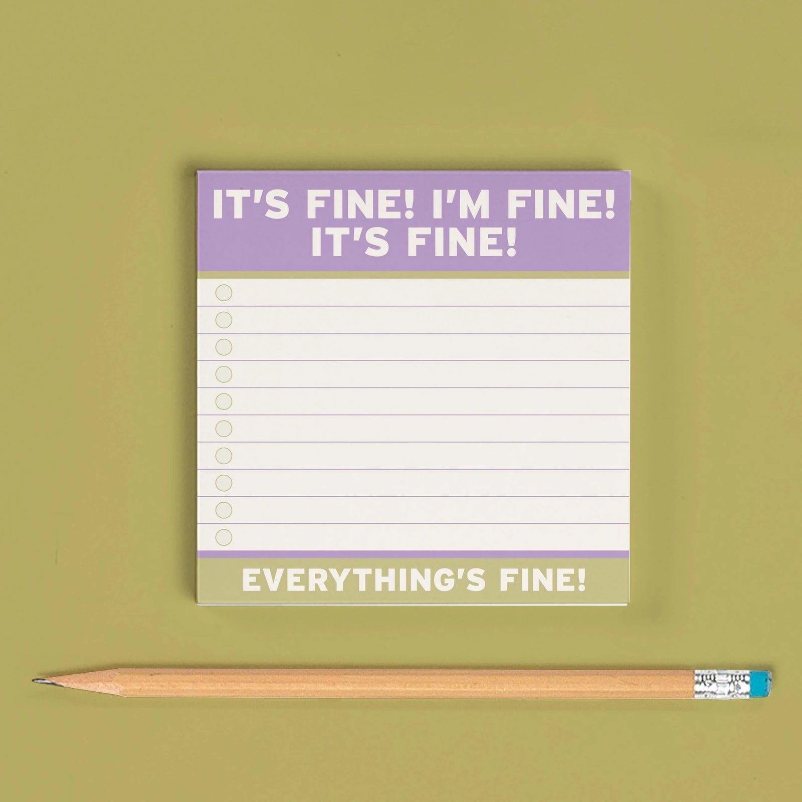 Notepad with 'It's fine! I'm fine! Everything's fine!' text on a green background