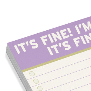Notepad with 'It's Fine! I'm Fine!' text on a purple cover