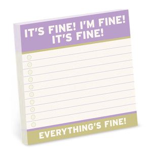Notepad with text 'It's fine! I'm fine! It's fine!' and 'Everything's fine!' on a white background