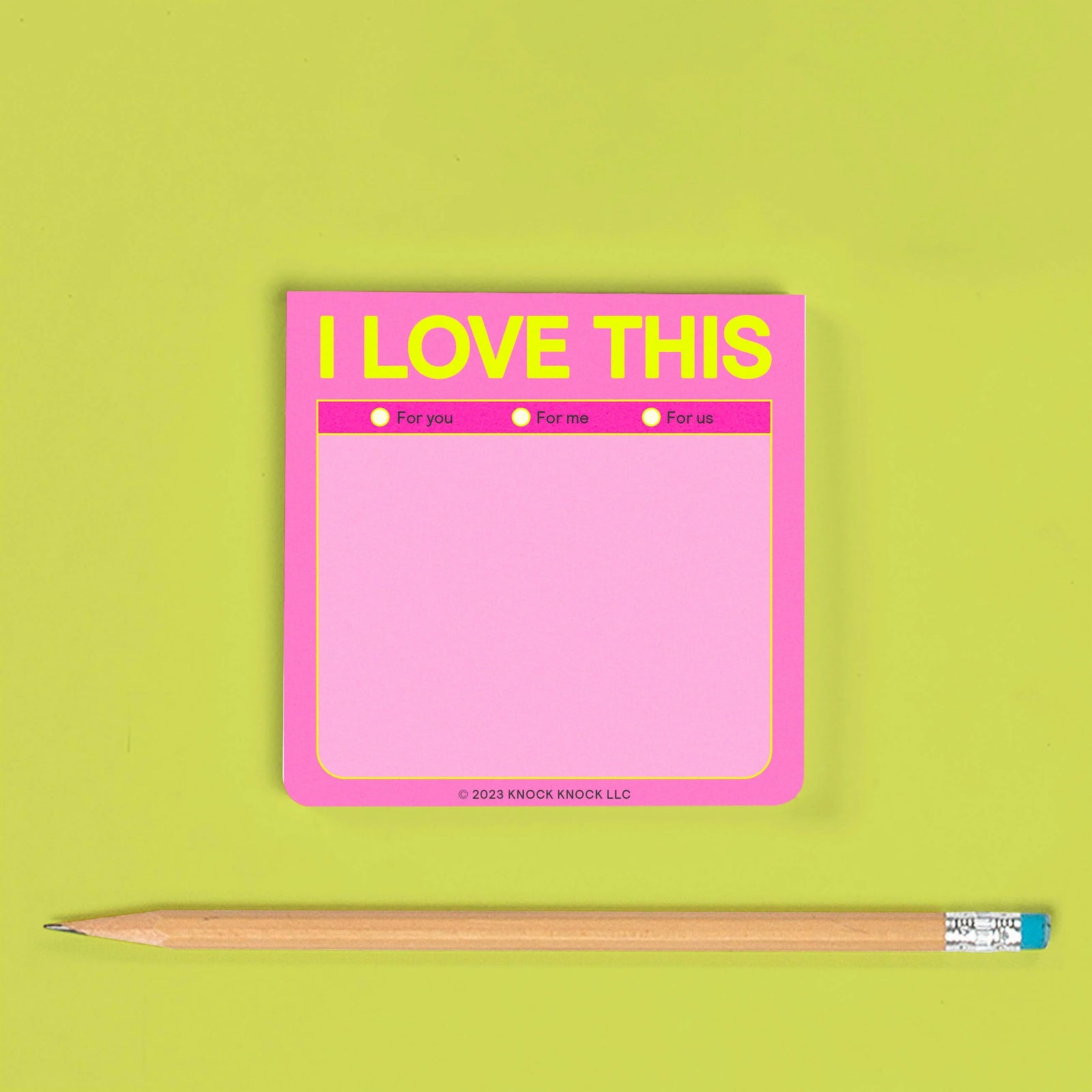 Pink notepad with 'I LOVE THIS' text on a green background