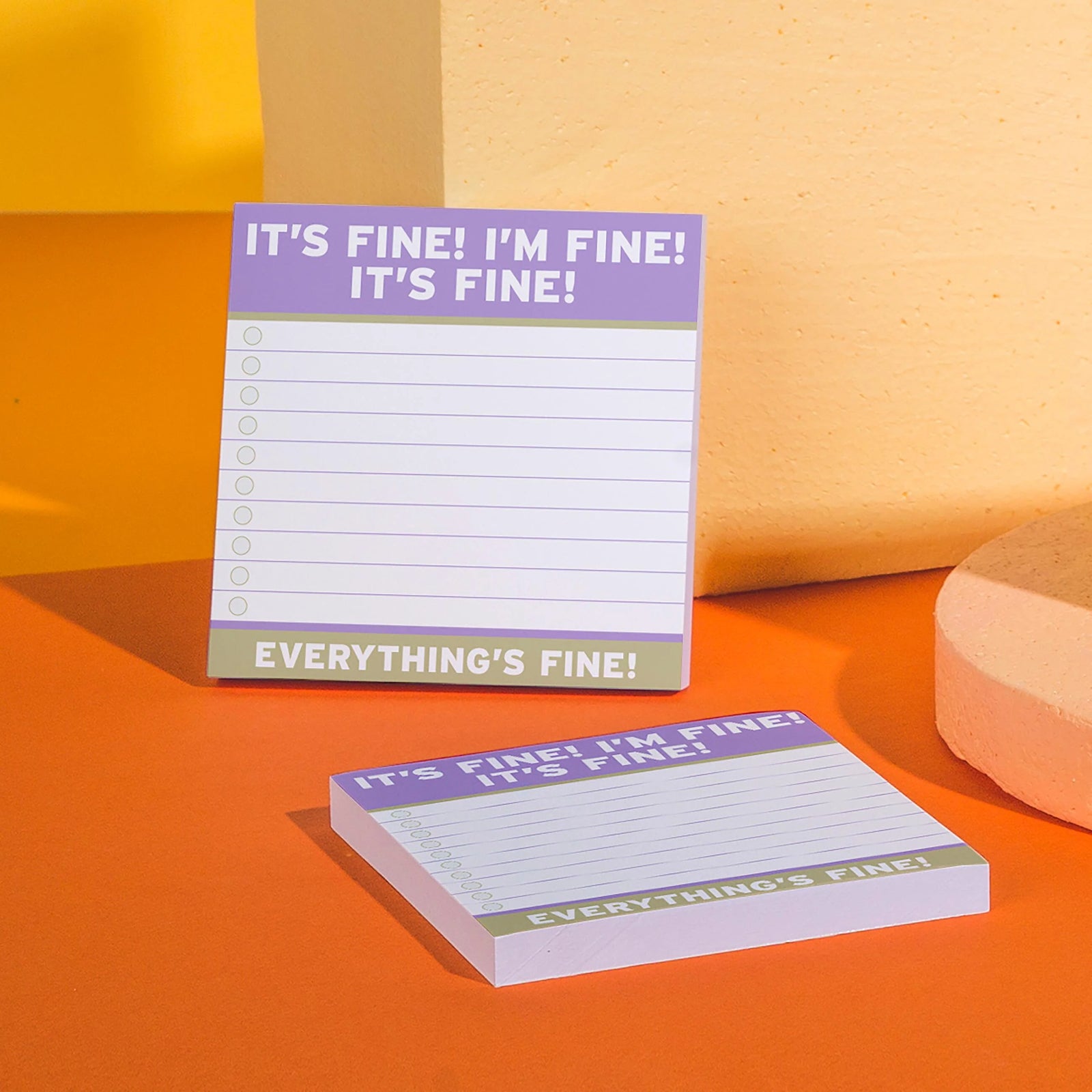 Notepad with 'It's fine! I'm fine! Everything's fine!' text on a green background