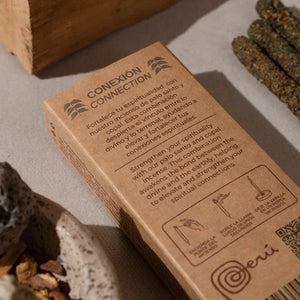 Brown packaging labeled 'Conexión' with cannabis products on a neutral background