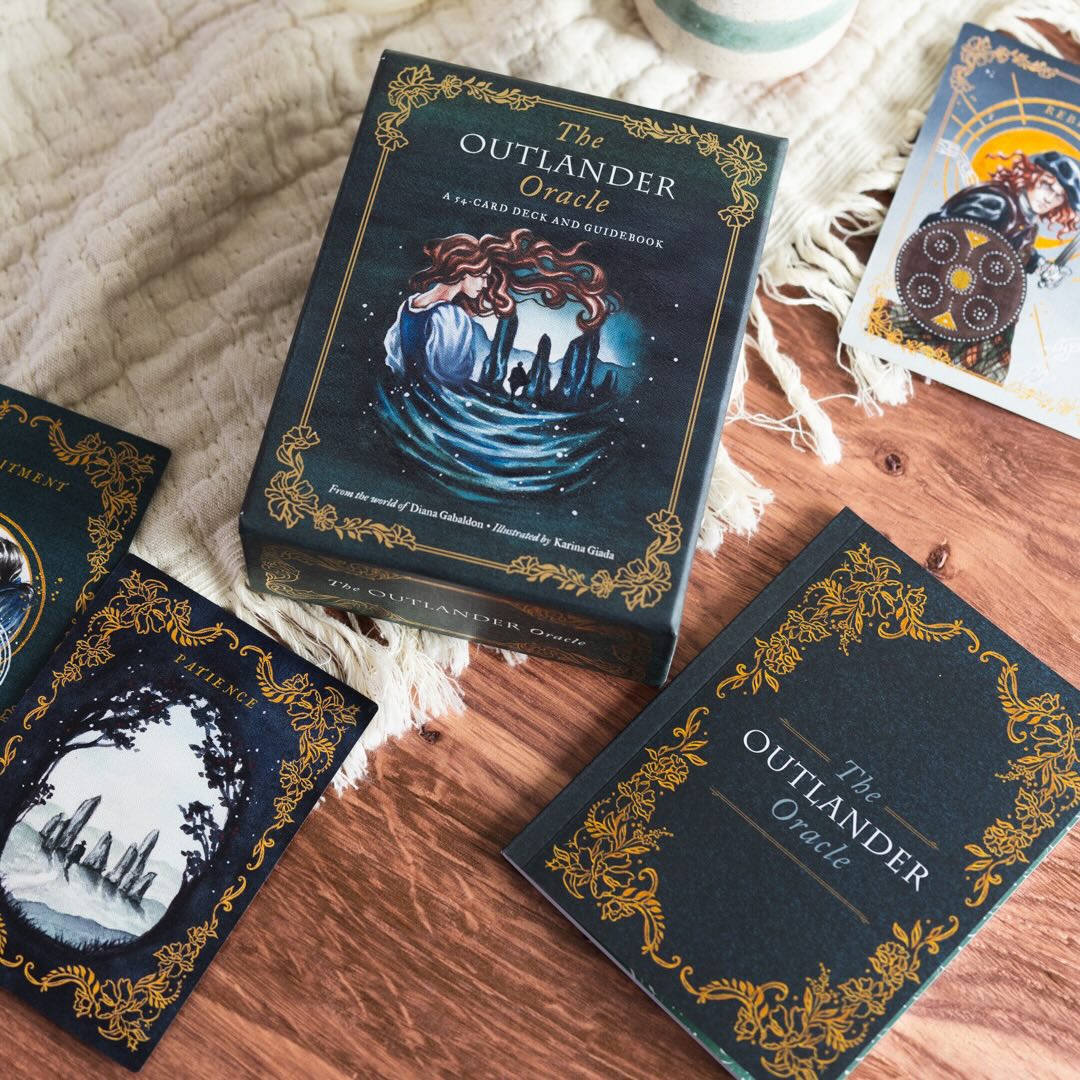 The Outlander Oracle card deck on cream colored fabric and wood