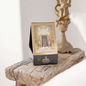 Packaging of 'The Inner Temple Oracle' on a wooden surface with a blurred background