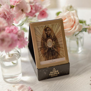 Oracular card from 'The Inner Temple Oracle' with pink flowers in the background