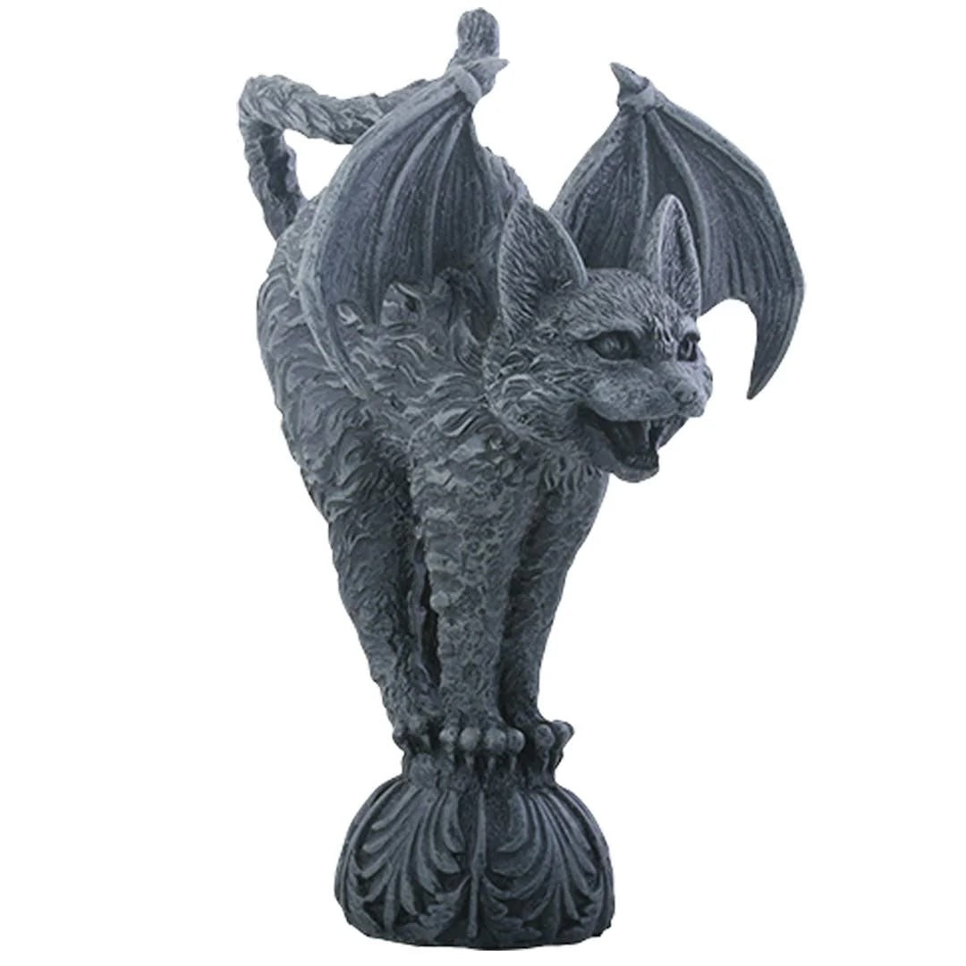 Gray cat gargoyle statue with raised bat wings, a curled upright tail, and bared fangs, perched on an ornate pedestal.