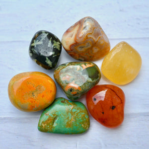 Collection of colorful marbled stones on a light gray background
