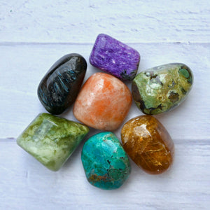 Colorful stones on a white wooden surface