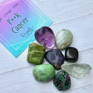Colorful crystals on a white surface with a card in the background