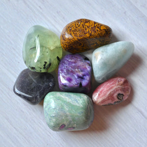 Assorted colorful stones on a white surface