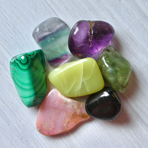 Assorted colorful crystals on a white surface