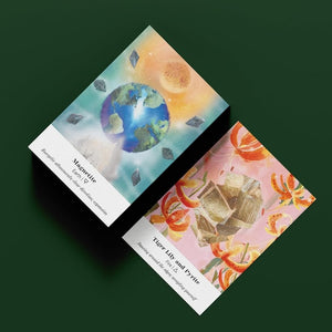 Two colorful oracle cards with Earth and crystal designs on a dark green background