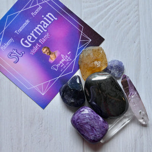 Crystal stones and a card with 'St. Germain' on a white surface