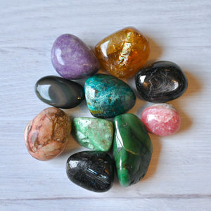 Assorted colorful crystals on a light wooden surface