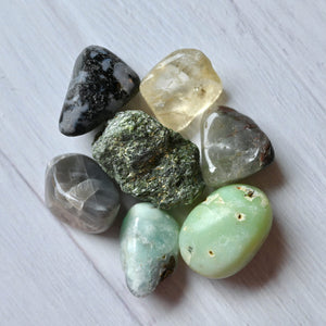 Collection of various colored stones on a white surface
