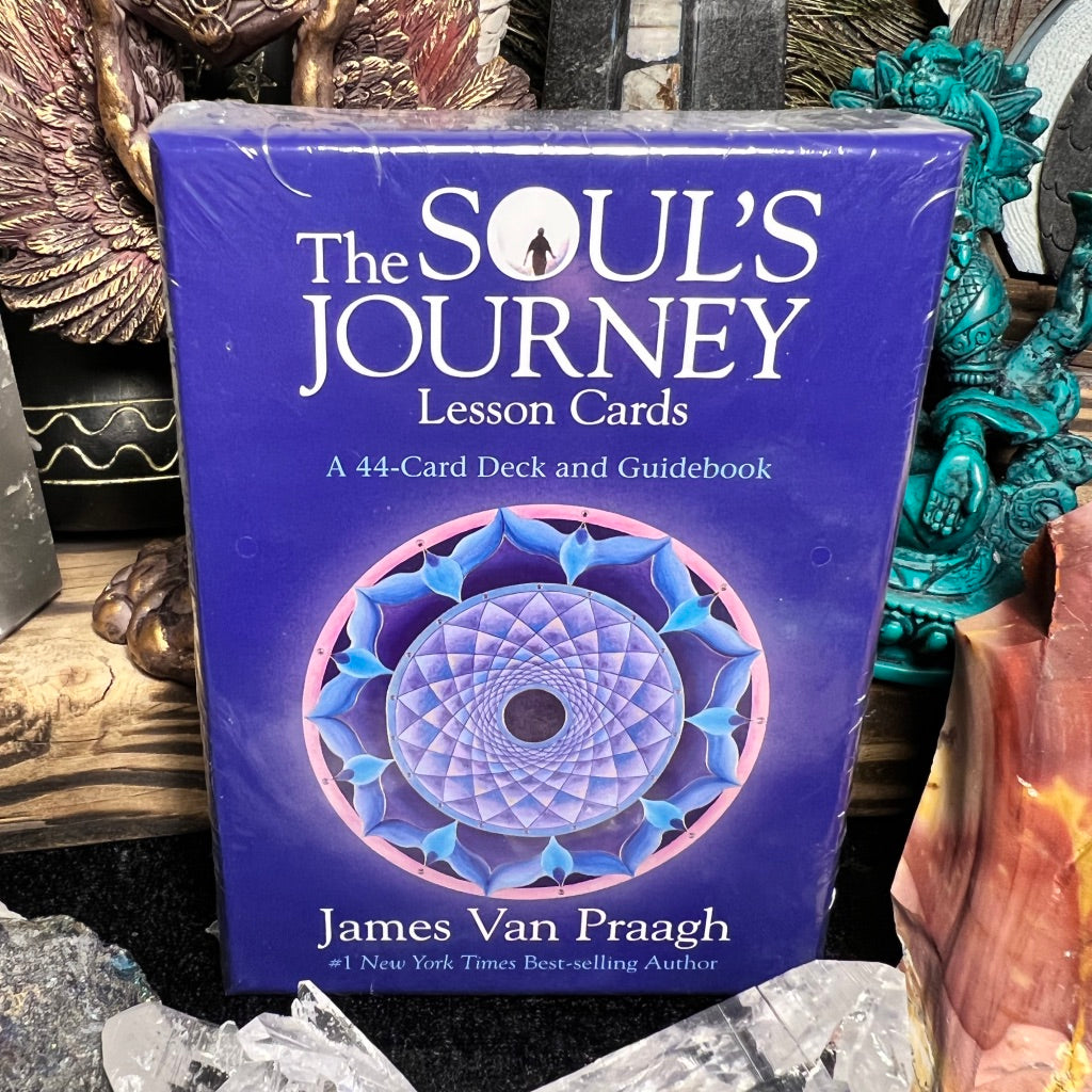 A packaged card deck titled 'The Soul's Journey Lesson Cards' by James Van Praagh, displayed among various spiritual and metaphysical items.